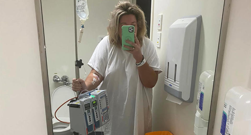 Abbey Smith takes a selfie in a hospital mirror